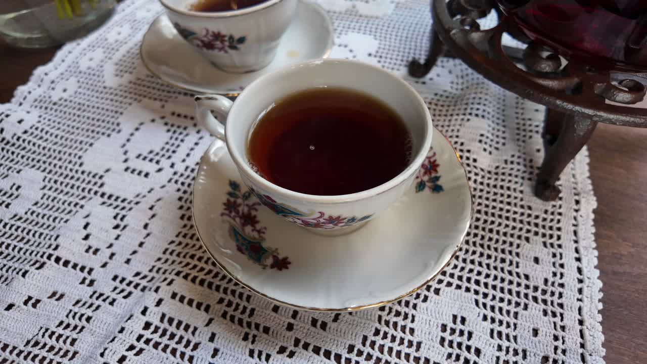 Tea cups with lace tablecloth