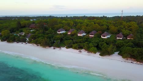 aerial drone shot over tropical resort cabins and hotel rooms in tanzania africa