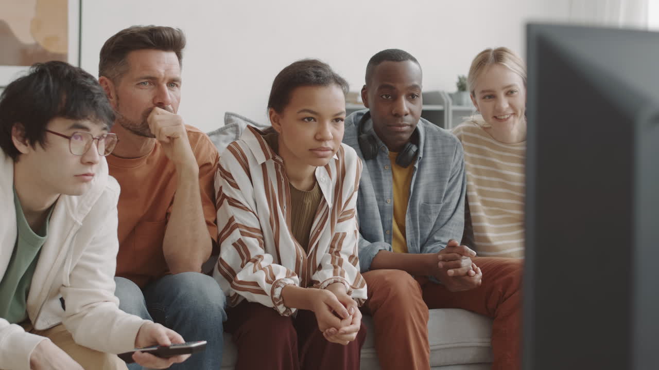 Friends Watching Interesting TV Program