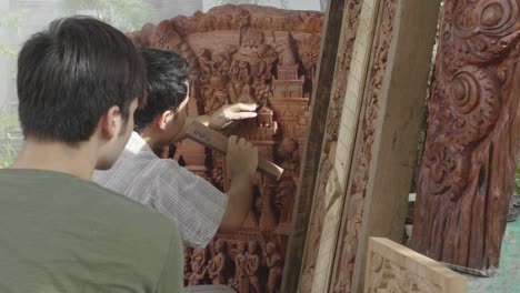 carpenter show to his student how to carve wooden, slow motion