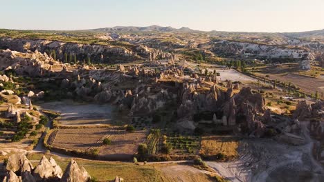 Toma-Aérea-Acercándose-A-La-Formación-Rocosa-En-Capadocia-Durante-La-Hora-Dorada