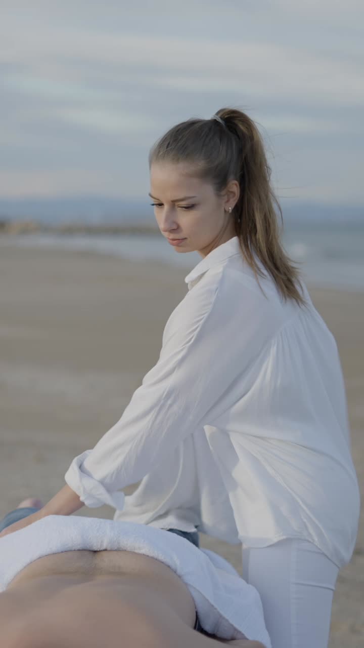 Woman Prepares for an Outdoor Massage Session on the Beach
