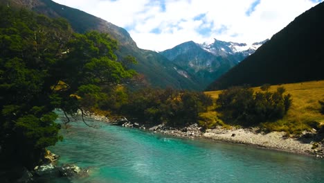 aerial overlooking magnificent crystal-clear turquoise color mountain river in mount aspiring national park - dolly slide right