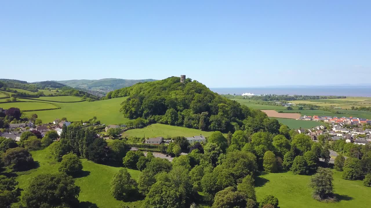 Aerial view of the Dunster Conygar tower and surrounding areas full of trees near Dunster castle, Somerset, England.