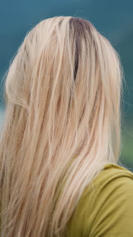 thoughtful blonde woman hiker enjoys mountain valley with river beauty spending time at highland nature reserve on nasty day closeup slow motion