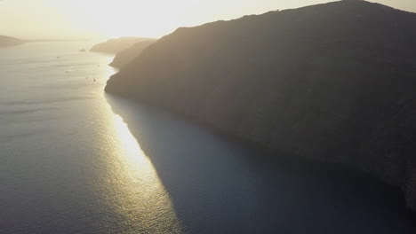 high santorini mountain aerial with golden mediterranean sunset