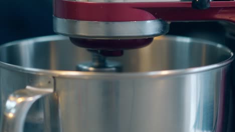 mixer automatically spins in metal bowl preparing cream