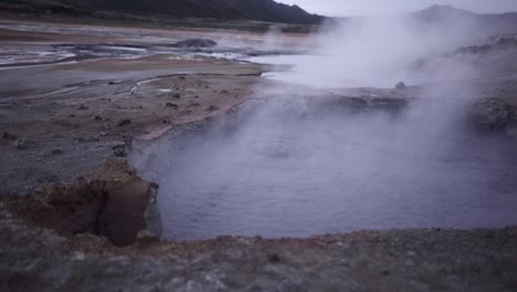 hot spring with steam in mountains