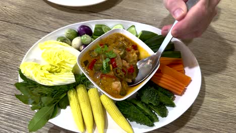 traditional thai dish with fresh vegetables and dip