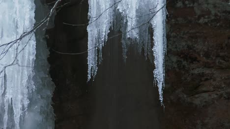 melting snow on ash cave in hocking hills state park, ohio, usa