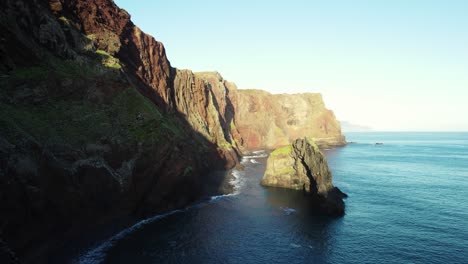 Drone-Footage-of-High-Green-Cliffs,-Rocks-and-Ocean-Waves