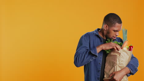 Person-counting-all-his-freshly-harvested-produce-in-a-paper-bag