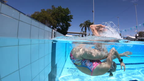 nadadora atleta profesional volteando y empujando la pared bajo el agua, cámara lenta de 4k