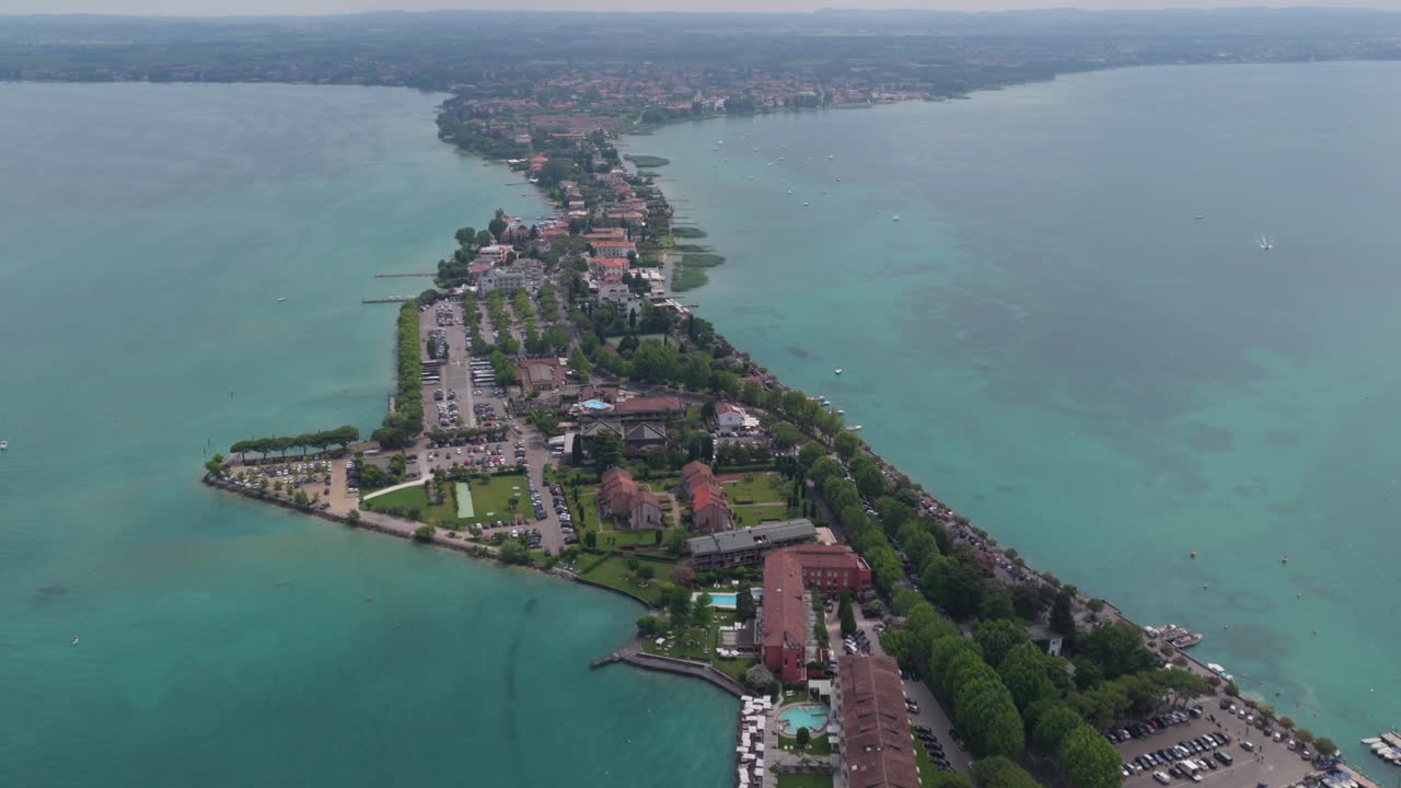 Long peninsula of Sirmione with castle at the tip extending into Lake Garda