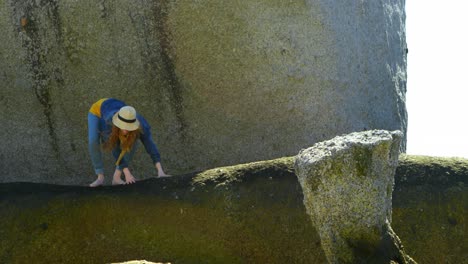 woman standing on a rock at beach 4k