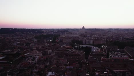 Backwards-flyover-of-Roman-streets-at-sunset-with-Vatican-City-in-the-background