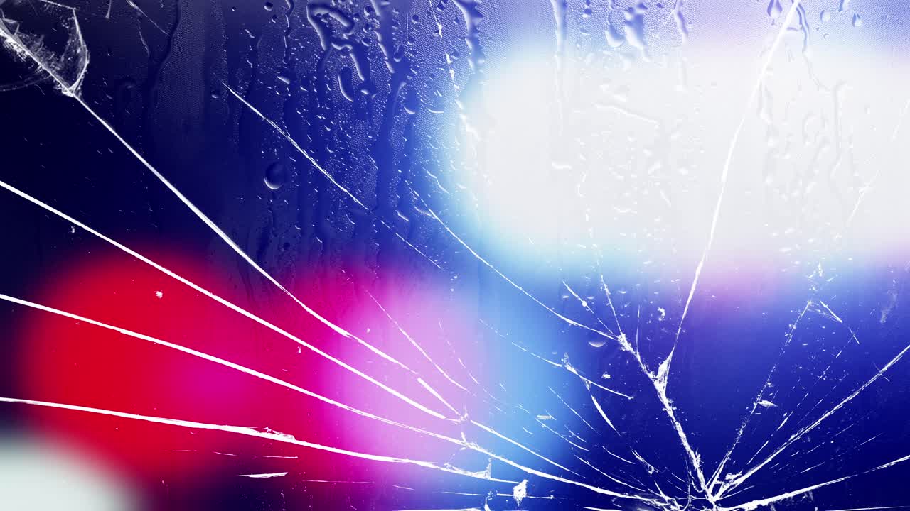 Cracked glass with raindrops and flashing police lights. Shattered glass with pulsating red and blue police lights and rain streaks. Abstract background for crime, emergency, danger, urban drama,vfx