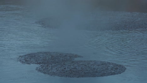 boiling hot geothermal volcanic mud pool, closeup shot steamy lake bubbling mud and steam