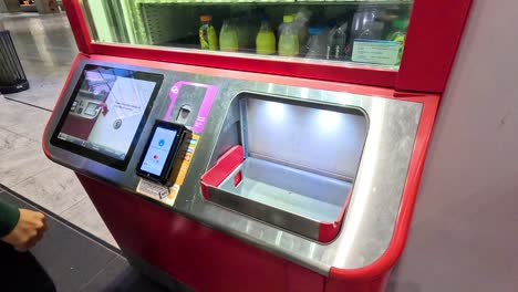 man interacts with a touchscreen beverage dispenser