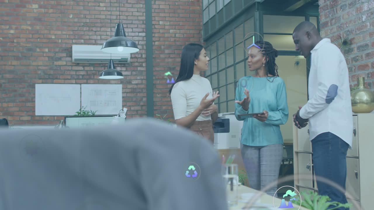 Animation of multiple icons over diverse coworkers standing and discussing in office