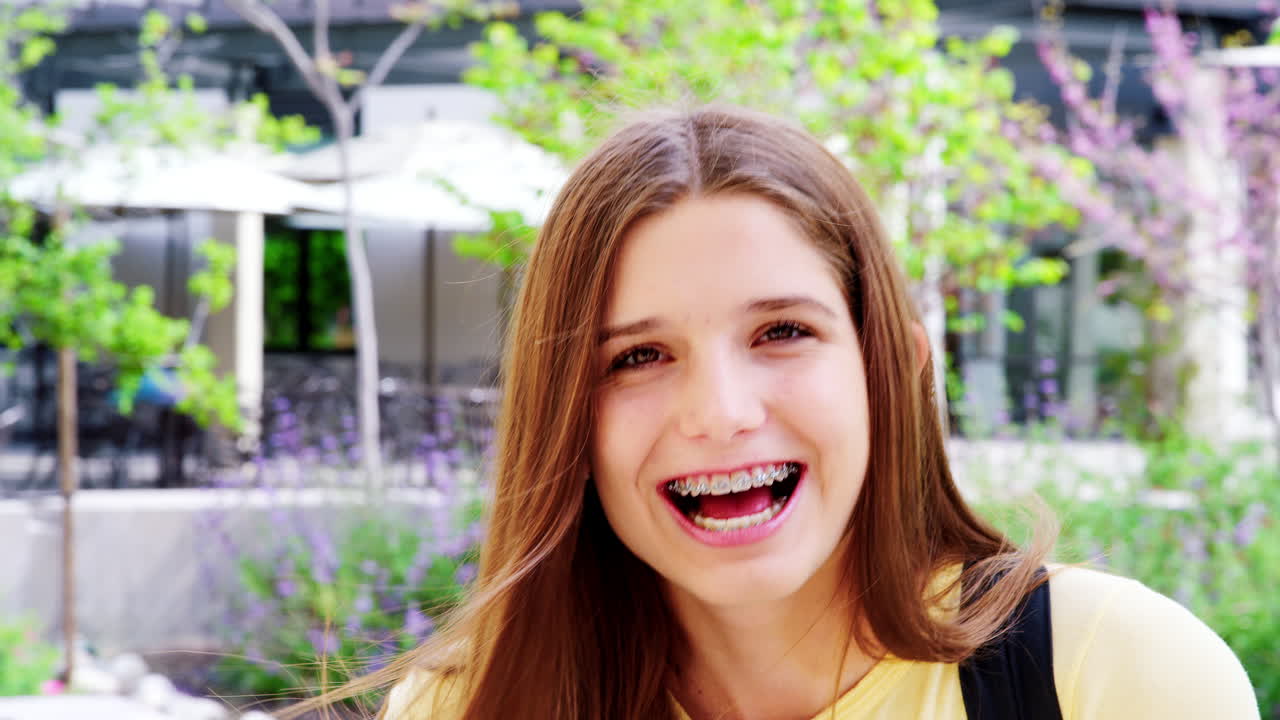 Portrait Of Female High School Student Outside College Buildings Shot In Slow Motion