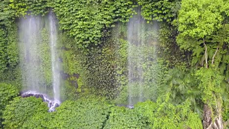 revealing waterfall in tropical rain forest jungle dramatic aerial view flight inking down drone footage benang kelambu lombok indonesia 2017 cinematic view from above tourist guide by philipp marnitz