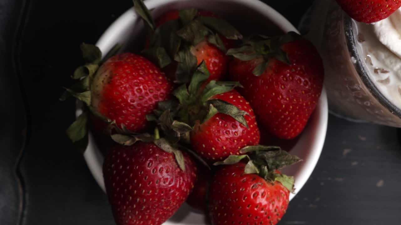 Pink cocktail drink with strawberry liqueur, vanilla vodka and cream. Party drink with strawberries. Fruit cocktail with fresh strawberries as a garnish. Cold and refreshing