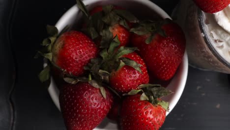 pink cocktail drink with strawberry liqueur, vanilla vodka and cream. party drink with strawberries. fruit cocktail with fresh strawberries as a garnish. cold and refreshing