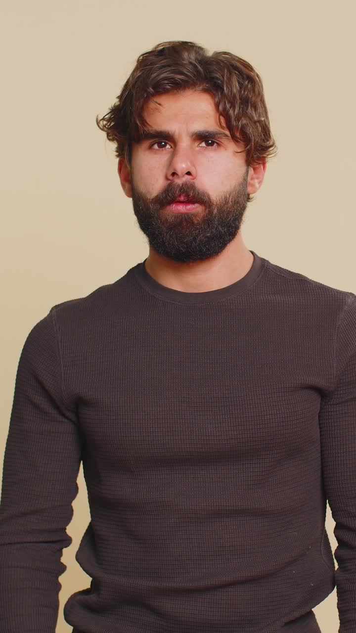 Indian shocked bearded man guy closing eyes with hands showing stop gesture over beige background
