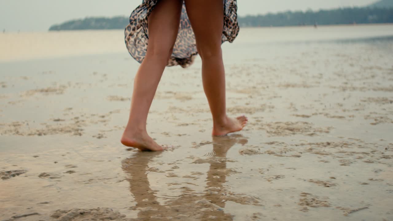 Woman Walking Barefoot on Wet Beach Sand