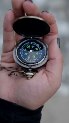 hand holding a compass