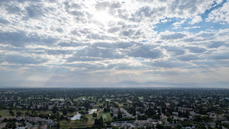 drone hyperlapse of golf course in early morning with partly cloudy sky and cloud shadows over golf course