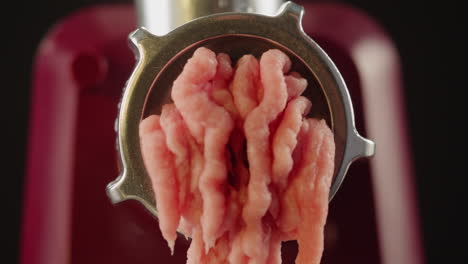 ground meat coming out of a meat grinder