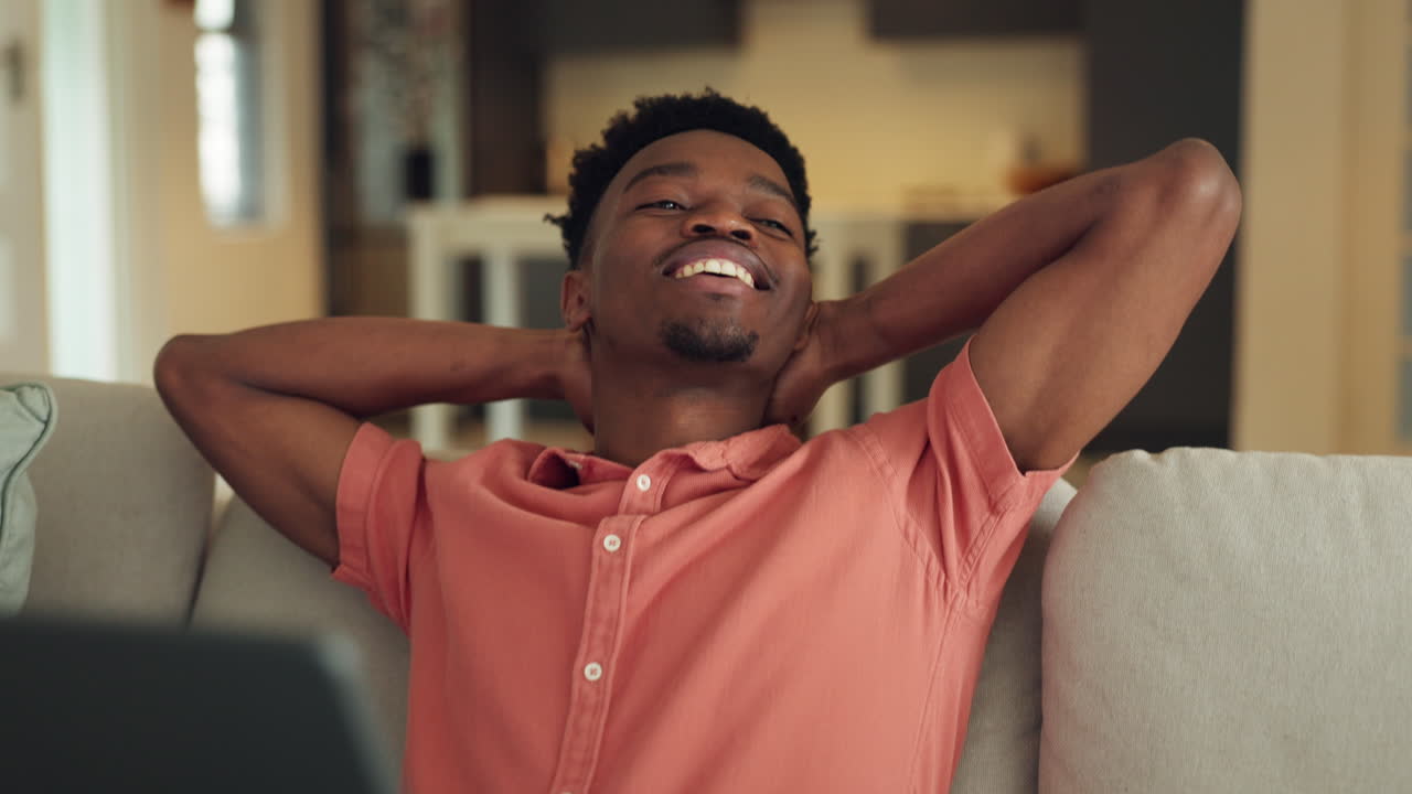 Happy learning online, man with laptop on sofa