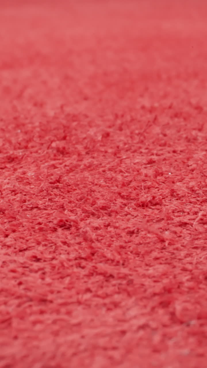 Fluffy reverse side of painted red cow leather sheet as background macro view. Material prepared in sewing shop. Design ideas and decorative techniques