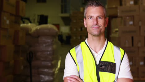 warehouse worker walking towards camera and smiling