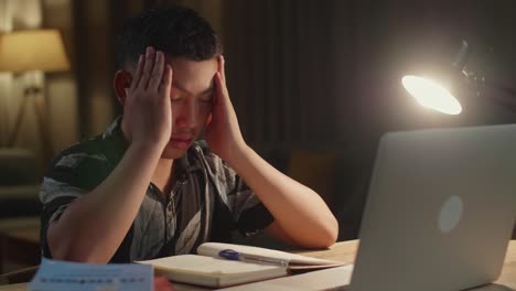teenager stressed during nighttime studying session