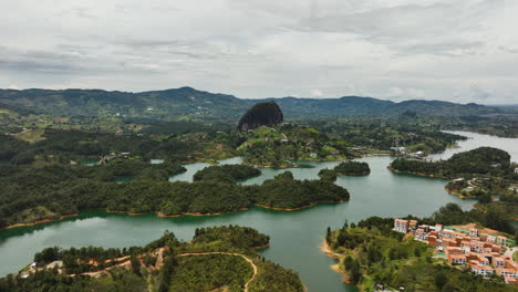 Panorama-Drohnenaufnahme,-Die-Den-Monolithen-Piedra-Del-Peñol-Im-Wolkigen-Guatape,-Kolumbien,-Umkreist