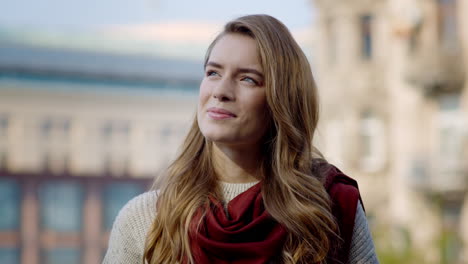 smiling woman standing outdoors. pretty girl enjoying sunny day outside