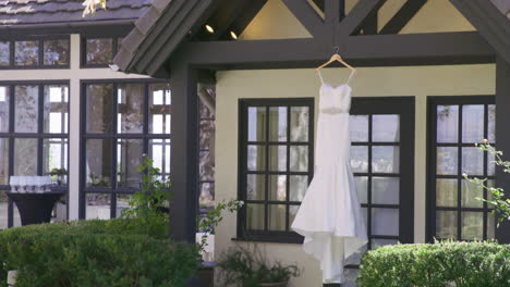 bride white wedding dress hanging outside of the bridal suite room