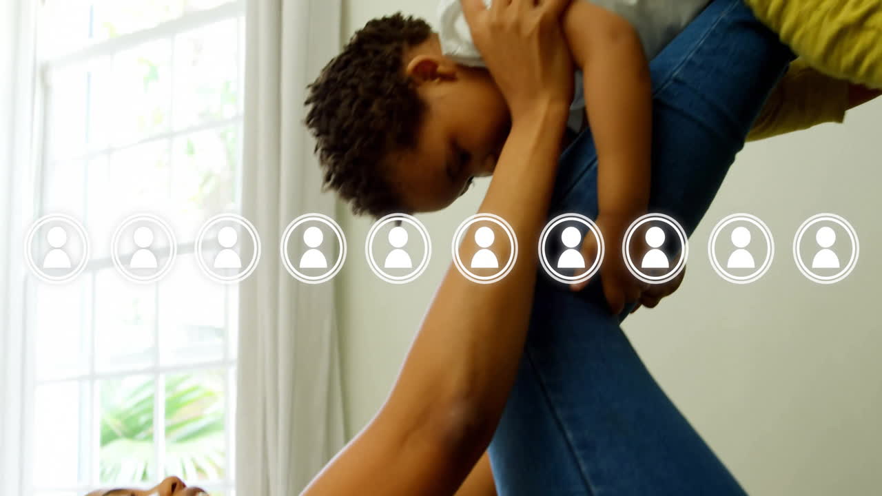 sosteniendo a un niño y sonriendo, mujer con animación de red social superpuesta