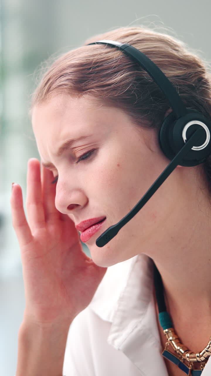 Giovane donna stressata che lavora in un call center con le cuffie