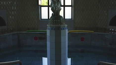 sculpture of children pioneers on column in spa bathtub pool, georgia