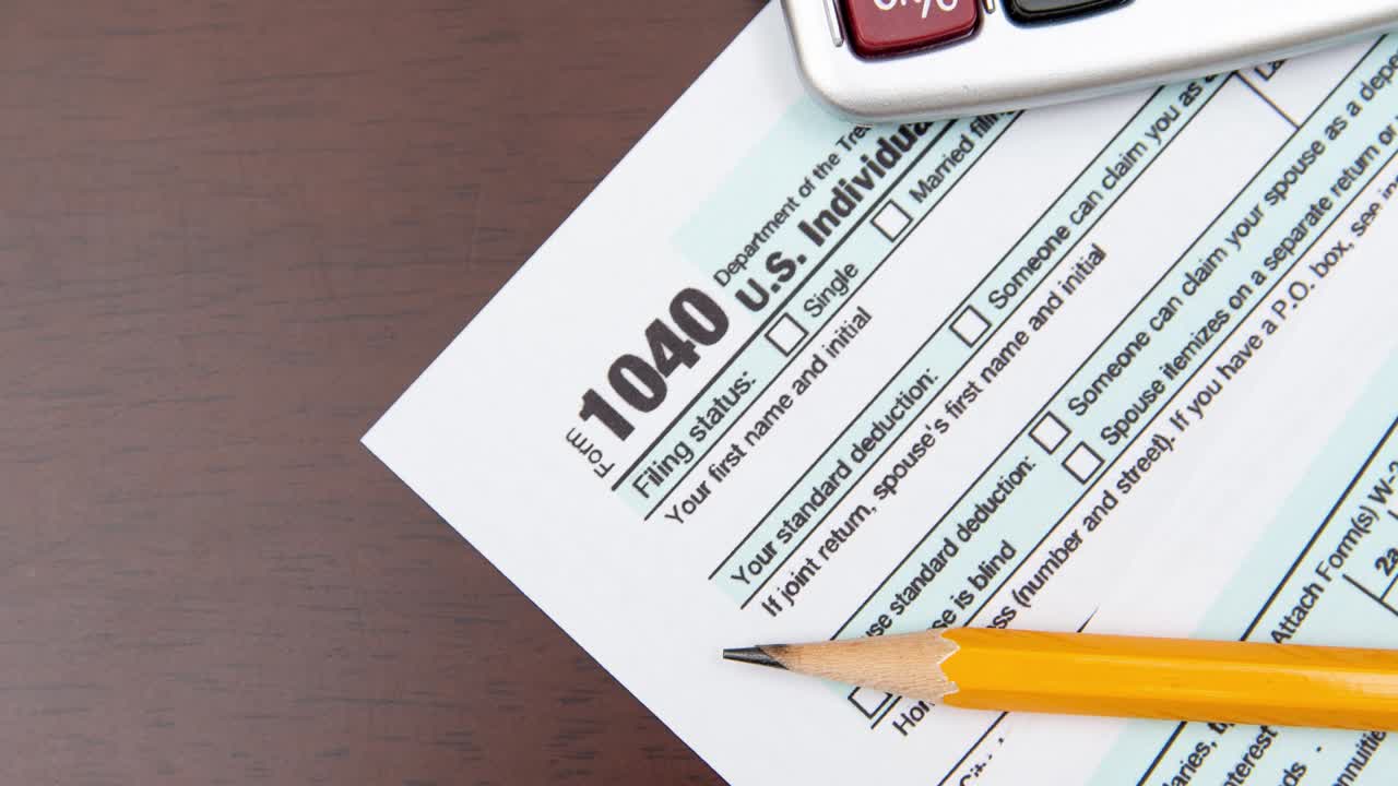 Pen on US TAX form Background. Tax Day concept