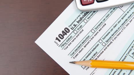 pen on us tax form background. tax day concept