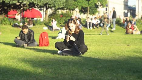 woman using phone in a park