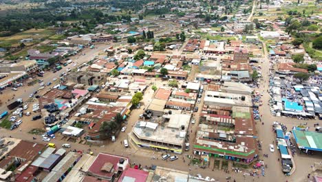 aerial view of cars and people at a open air market, in africa - reverse, drone shot