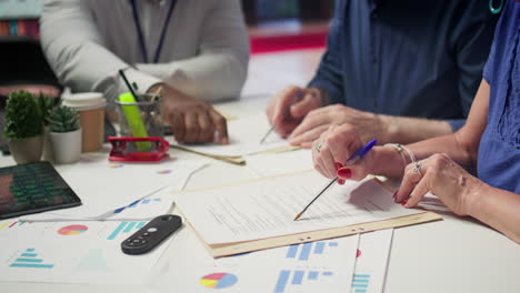 mature person signing a contract with insurance agency banker