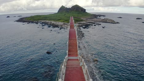 Aerial-flyover-8-arches-bridge-with-green-island-in-background-in-Taiwan---Taidong-county