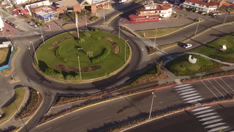 Aerial-panning-shot-of-beach-by-buildings-near-sea-against-sky,-drone-flying-over-shore---Punta-del-Este,-Uruguay